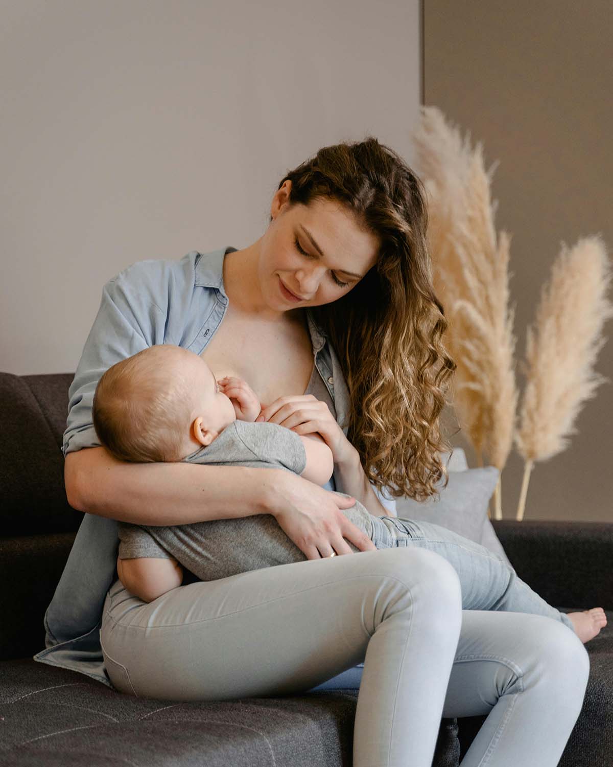 A mother nurses her infant.