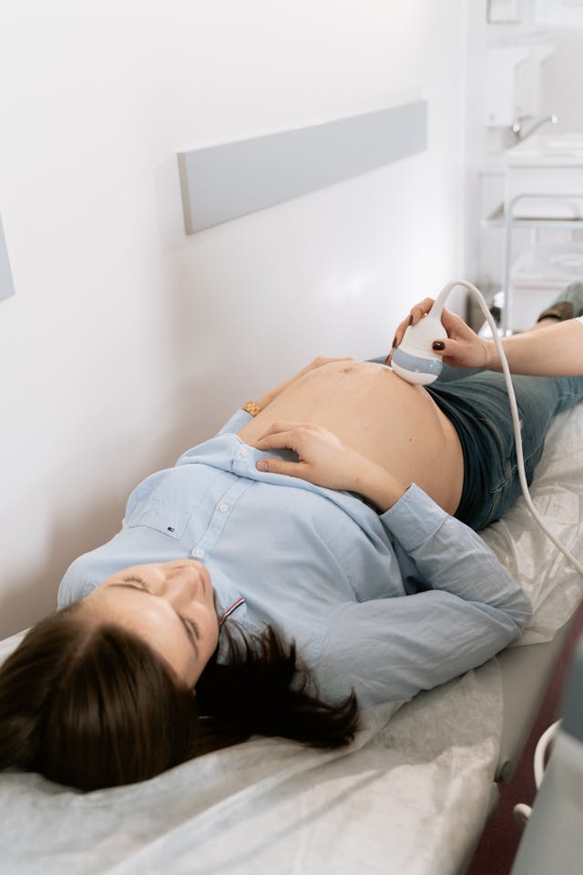 A pregnant woman receives an ultrasound at a clinic.